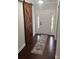 Bright foyer featuring a white front door, sidelights, wood floors, and a sliding barn door at 8011 Caliterra Dr, Charlotte, NC 28227
