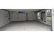 Spacious two car garage with epoxy floors, storage and shelving at 8011 Caliterra Dr, Charlotte, NC 28227