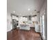 Open-concept kitchen with stainless steel appliances, white cabinets, and a center island at 8011 Caliterra Dr, Charlotte, NC 28227