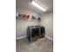 Well-lit laundry room with modern washer and dryer and shelving for storage at 8011 Caliterra Dr, Charlotte, NC 28227