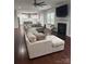 Open concept living room with large sectional, fireplace, and views of the modern eat-in kitchen at 8011 Caliterra Dr, Charlotte, NC 28227