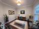 Well-lit home office with a modern desk, comfortable seating, and stylish decor at 8011 Caliterra Dr, Charlotte, NC 28227