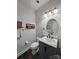 Chic powder room with a gray vanity, marble countertop, and stylish mirror at 8011 Caliterra Dr, Charlotte, NC 28227