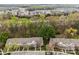 An aerial view of the townhome complex featuring mature trees and lush landscaping at 8230 Rudolph Rd, Charlotte, NC 28216