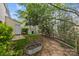 A view of the backyard featuring a metal raised garden bed, landscaping, and a wooden fence line at 8230 Rudolph Rd, Charlotte, NC 28216