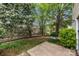 A view of the backyard featuring landscaping, a patio area, and mature trees at 8230 Rudolph Rd, Charlotte, NC 28216