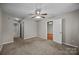 Large bedroom with neutral carpet and paint, a ceiling fan and two closets at 8230 Rudolph Rd, Charlotte, NC 28216
