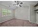 Well lit bedroom features a window, ceiling fan and built-in shelving at 8230 Rudolph Rd, Charlotte, NC 28216