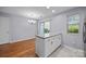 Dining room area features hardwood floors and granite topped island and view to the back patio at 8230 Rudolph Rd, Charlotte, NC 28216
