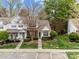 A view of the townhome featuring a well-maintained lawn and landscaped front yard at 8230 Rudolph Rd, Charlotte, NC 28216
