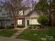 Charming townhome with brick and siding, green door and shutters, and landscaped front yard at 8230 Rudolph Rd, Charlotte, NC 28216