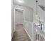 Upstairs hallway with railing and contemporary light fixtures near bedrooms at 8230 Rudolph Rd, Charlotte, NC 28216