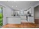 Bright kitchen boasts stainless appliances, granite countertops, white cabinets and hardwood floors at 8230 Rudolph Rd, Charlotte, NC 28216