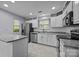 Bright kitchen boasts stainless appliances, white cabinets, and granite countertops at 8230 Rudolph Rd, Charlotte, NC 28216