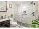 Bathroom featuring custom tiled walk-in shower with marble surround at 1013 East Dr, Gastonia, NC 28052