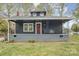 Charming home with a covered front porch and a red front door at 1013 East Dr, Gastonia, NC 28052