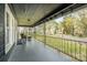Covered front porch with black metal railing and sitting area at 1013 East Dr, Gastonia, NC 28052