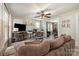 Well-lit living room with neutral walls, stylish accents, and connection to dining area at 1013 East Dr, Gastonia, NC 28052