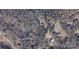 This aerial view showcases the expansive lot surrounded by mature trees, offering privacy and natural beauty at 104 Little River Trl, Fort Mill, SC 29707