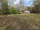 A view of the backyard with some chickens roaming around and a small storage shed at 104 Little River Trl, Fort Mill, SC 29707