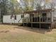 Exterior view of a home with a wooden back porch and a grassy area in the backyard at 104 Little River Trl, Fort Mill, SC 29707