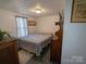 Well-lit bedroom with a neutral color scheme, comfortable bed, and hardwood-style floors at 104 Little River Trl, Fort Mill, SC 29707