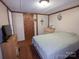 Simple bedroom with paneled walls, linoleum flooring, neutral paint, and modest decor at 104 Little River Trl, Fort Mill, SC 29707