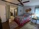 Comfortable bedroom featuring a decorative quilt, ceiling fan, and connecting bathroom with curtain divider at 104 Little River Trl, Fort Mill, SC 29707