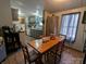 Inviting dining area with a wooden table, charming decor, and a view into the kitchen space at 104 Little River Trl, Fort Mill, SC 29707