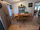 Bright dining area featuring a wooden table set and a view into adjacent living spaces at 104 Little River Trl, Fort Mill, SC 29707