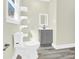 A serene bathroom featuring a gray vanity, open shelving, and wood-look flooring at 109 Broad St, Shelby, NC 28152