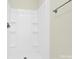A bright white shower features built-in shelving and sleek hardware at 109 Broad St, Shelby, NC 28152