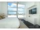 Bright bedroom with a large window, minimalist decor, and storage provides a tranquil city retreat at 1100 Metropolitan Ave # 314, Charlotte, NC 28204