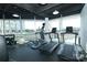 Well-equipped fitness center with treadmills, weights, and floor-to-ceiling windows offering neighborhood views at 1100 Metropolitan Ave # 314, Charlotte, NC 28204
