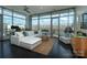 Bright living room featuring floor to ceiling windows, hardwood floors, and a comfortable white sofa at 1100 Metropolitan Ave # 314, Charlotte, NC 28204