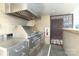 Gourmet outdoor kitchen featuring a stainless steel grill, prep area, and bar seating, perfect for entertaining at 1100 Metropolitan Ave # 314, Charlotte, NC 28204