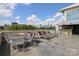 Relax on the rooftop terrace with lounge chairs and a table, enjoying stunning city skyline views at 1100 Metropolitan Ave # 314, Charlotte, NC 28204