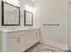 Bathroom with double sinks, modern cabinets, fixtures and mirrors with a wood floor at 11019 Kilkenny Dr # 41, Charlotte, NC 28277