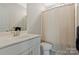 Bathroom featuring a single sink vanity, standard toilet and shower with a simple curtain at 11019 Kilkenny Dr # 41, Charlotte, NC 28277