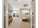 Open primary bedroom with a ceiling fan, sitting area and doorway to an adjacent room at 11019 Kilkenny Dr # 41, Charlotte, NC 28277