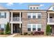 Brick and siding townhome featuring a covered balcony and manicured landscaping at 11019 Kilkenny Dr # 41, Charlotte, NC 28277