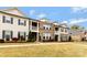 Row of brick and siding townhomes with covered balconies and well-maintained lawns at 11019 Kilkenny Dr # 41, Charlotte, NC 28277
