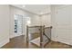 Hallway landing with hardwood floors, neutral walls and a staircase with decorative wood and iron railing at 11019 Kilkenny Dr # 41, Charlotte, NC 28277
