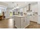 Well-lit kitchen with stainless steel appliances, white cabinets, large island, and access to the outdoor patio at 11019 Kilkenny Dr # 41, Charlotte, NC 28277