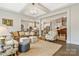 Spacious living room with hardwood floors, coffered ceilings, and a view into the open-concept kitchen and dining area at 11019 Kilkenny Dr # 41, Charlotte, NC 28277