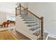 Beautiful staircase with wood treads, iron spindles and wood railing in a home with light walls at 11019 Kilkenny Dr # 41, Charlotte, NC 28277