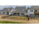 Expansive backyard features a well-maintained lawn, a covered patio, and a privacy fence for outdoor enjoyment at 11036 Shreveport Dr, Huntersville, NC 28078