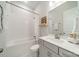 Clean bathroom with white tiled walls, a bathtub, and a modern vanity at 11036 Shreveport Dr, Huntersville, NC 28078