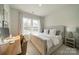 Comfortable bedroom featuring a large window, neutral tones, and a desk setup at 11036 Shreveport Dr, Huntersville, NC 28078