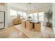 Bright dining room with large windows, modern light fixture, hardwood floors, and stylish furnishings at 11036 Shreveport Dr, Huntersville, NC 28078